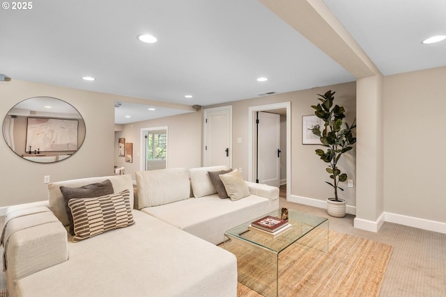 living area featuring visible vents, recessed lighting, light colored carpet, and baseboards