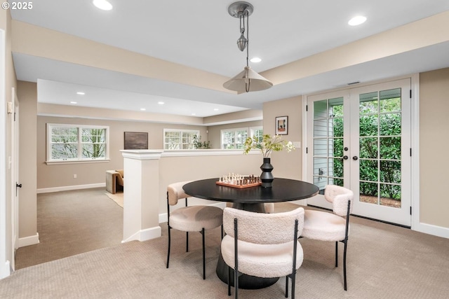 dining room with recessed lighting, light colored carpet, and baseboards