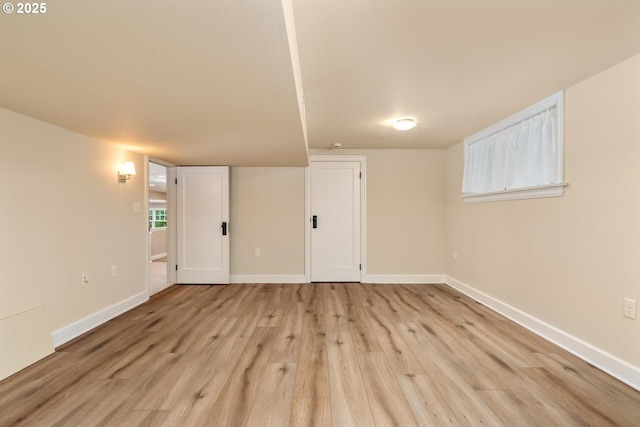 interior space featuring light wood-style flooring and baseboards