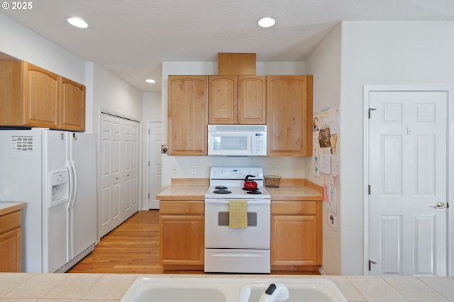 17146 SE 23rd Dr Unit 20, Vancouver, WA 98683 - kitchen featuring white appliances, tile counters, recessed lighting, light brown cabinets, and light wood finished floors