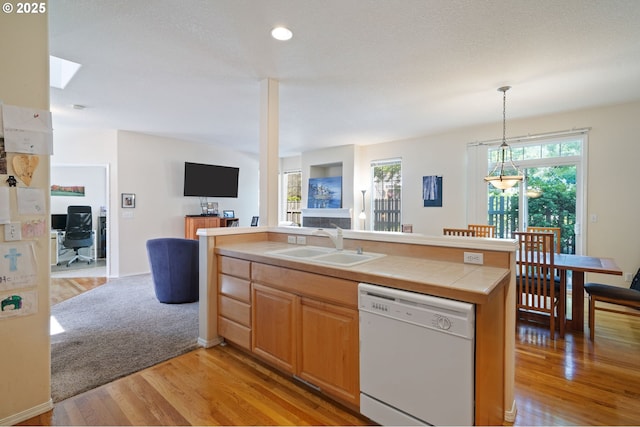 17146 SE 23rd Dr Unit 20, Vancouver, WA 98683 - kitchen with white dishwasher, a sink, open floor plan, light wood-style floors, and tile countertops