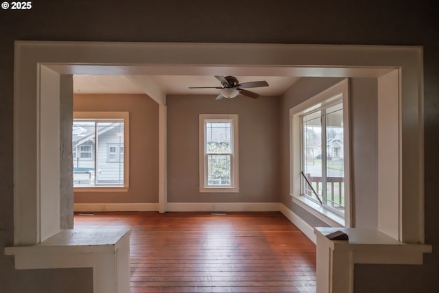 empty room with hardwood / wood-style flooring and ceiling fan