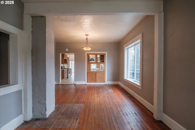 unfurnished dining area featuring hardwood / wood-style floors