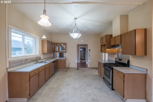 kitchen with appliances with stainless steel finishes, sink, and decorative light fixtures