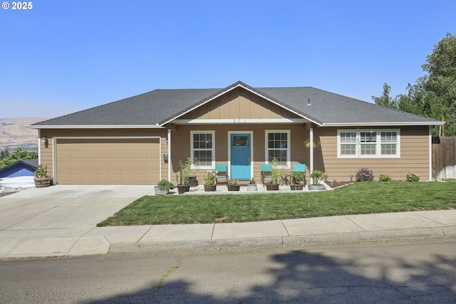 view of front facade featuring a garage, covered porch, driveway, a front lawn, and board and batten siding