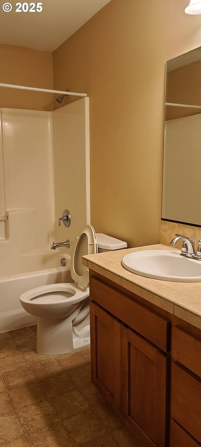 full bathroom with tile patterned flooring, shower / washtub combination, vanity, and toilet