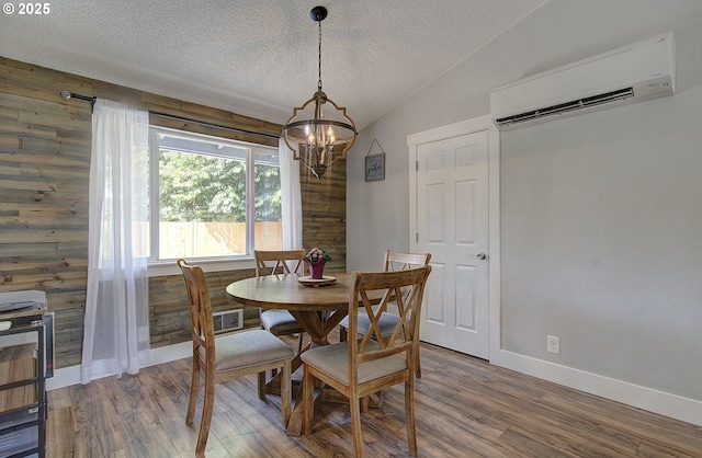 11204 NE 85th Cir, Vancouver, WA 98662 - dining space with a wall mounted air conditioner, a textured ceiling, a chandelier, wood finished floors, and lofted ceiling