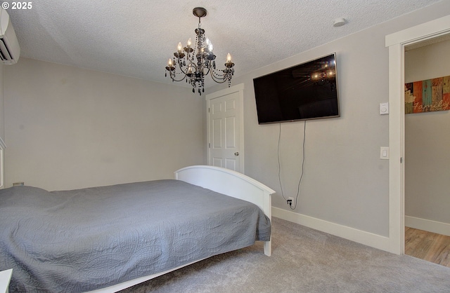 11204 NE 85th Cir, Vancouver, WA 98662 - bedroom featuring a chandelier, an AC wall unit, a textured ceiling, and carpet