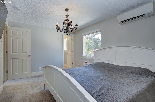 11204 NE 85th Cir, Vancouver, WA 98662 - bedroom with a wall unit AC, a chandelier, light carpet, and a textured ceiling