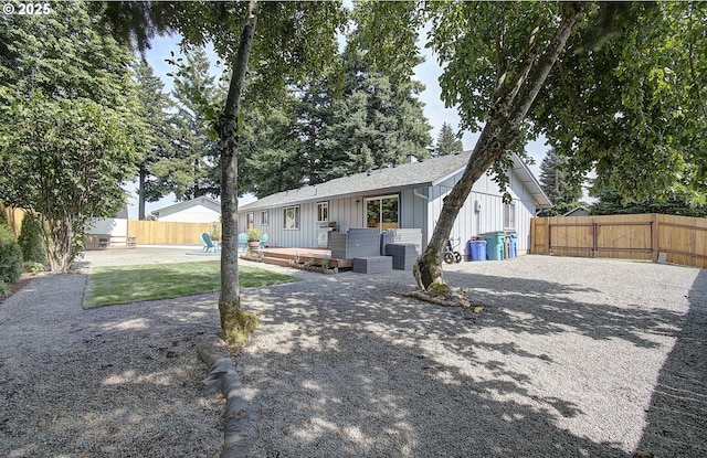 11204 NE 85th Cir, Vancouver, WA 98662 - view of front of property with board and batten siding, a wooden deck, a fenced backyard, and a shingled roof
