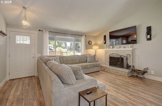 11204 NE 85th Cir, Vancouver, WA 98662 - living room with a textured ceiling, wood finished floors, a brick fireplace, and lofted ceiling