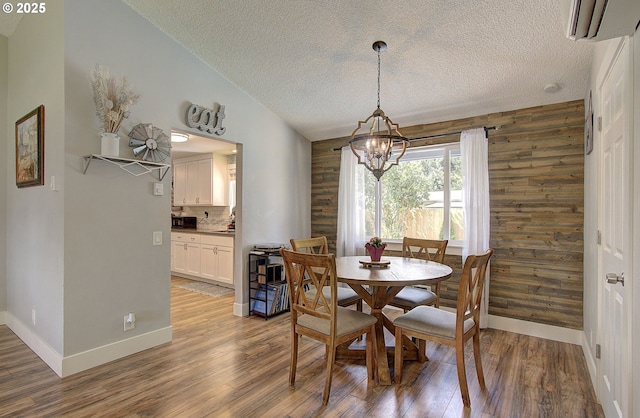 11204 NE 85th Cir, Vancouver, WA 98662 - dining room featuring a wall unit AC, a chandelier, a textured ceiling, and light wood-style floors
