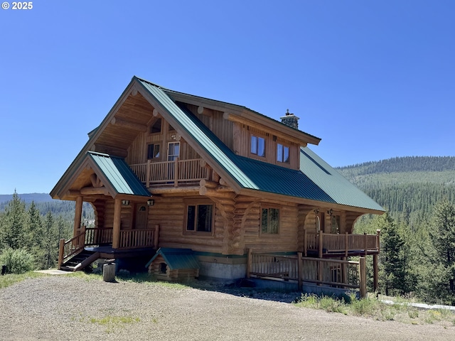 44552 Red Boy Rd, Granite, OR 97877 - rear view of property featuring log siding, a forest view, and covered porch