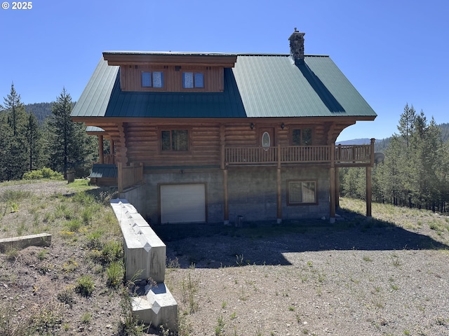 44552 Red Boy Rd, Granite, OR 97877 - rear view of property with log siding, a chimney, an attached garage, and a metal roof
