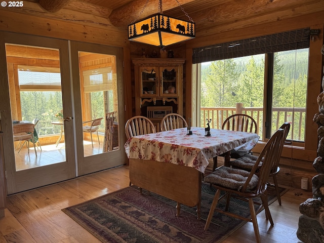 44552 Red Boy Rd, Granite, OR 97877 - dining area with french doors, light wood-style flooring, and wood walls