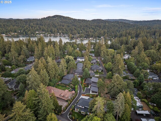3884 Lake Grove Ave, Lake Oswego, OR 97035 - aerial overview of property's location with a forest, a large body of water, and nearby suburban area