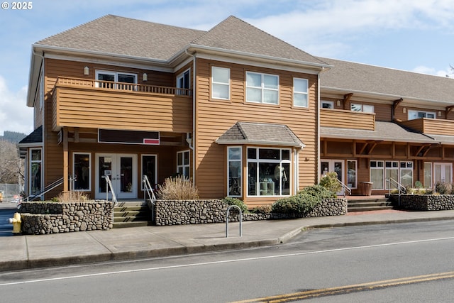 123 S Hemlock St # 201, Cannon Beach, OR 97110 - view of front of property featuring french doors, a balcony, and a shingled roof