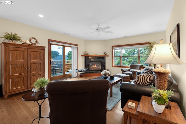 123 S Hemlock St # 201, Cannon Beach, OR 97110 - living area featuring a ceiling fan, a tile fireplace, wood finished floors, and recessed lighting