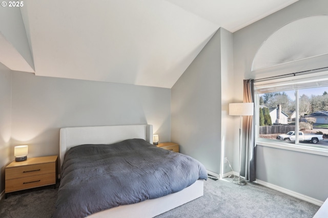 bedroom featuring baseboards, carpet flooring, and vaulted ceiling