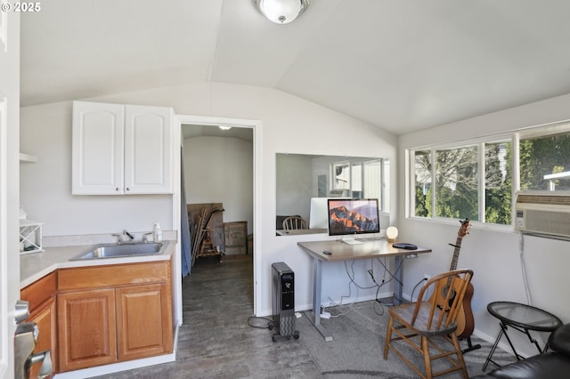 kitchen featuring cooling unit, lofted ceiling, a sink, light countertops, and white cabinetry