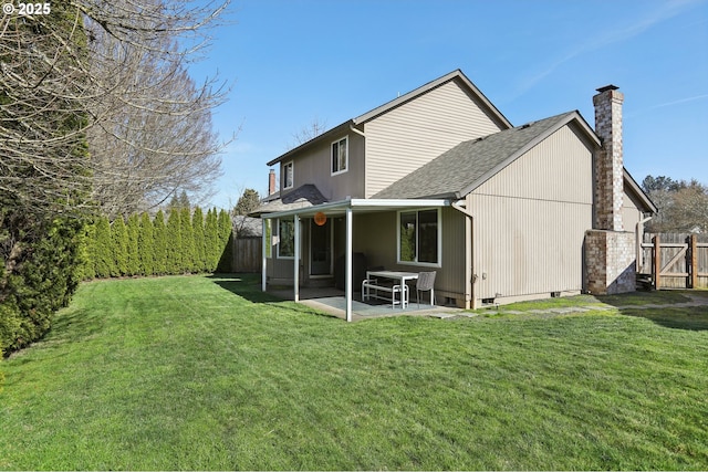 back of house featuring fence, crawl space, a chimney, a yard, and a patio area