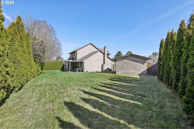 view of yard featuring a fenced backyard and a sunroom