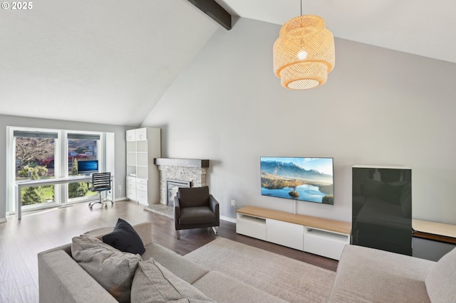 living area featuring wood finished floors, baseboards, high vaulted ceiling, a fireplace, and beamed ceiling