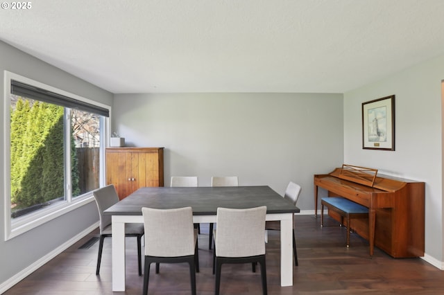 dining area with visible vents, wood finished floors, and baseboards