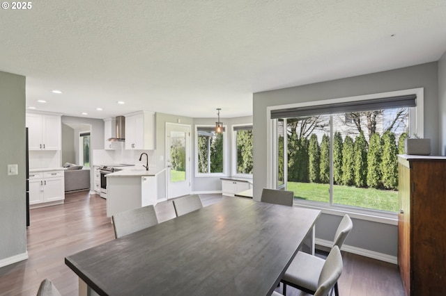 dining room with recessed lighting, baseboards, a textured ceiling, and dark wood-style flooring