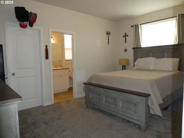 carpeted bedroom featuring connected bathroom