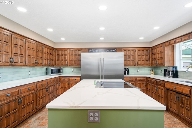 41266 Manitau Rd SE, Stayton, OR 97383 - kitchen with stainless steel appliances, a center island, tasteful backsplash, brown cabinets, and recessed lighting