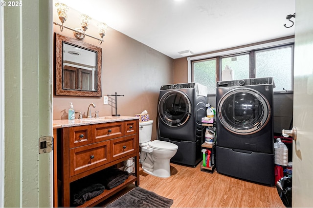 41266 Manitau Rd SE, Stayton, OR 97383 - bathroom with washing machine and clothes dryer, wood finished floors, and vanity