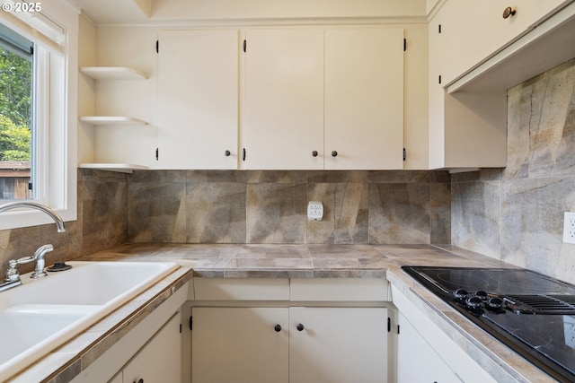 2222 34th Ave, Albany, OR 97322 - kitchen with open shelves, black electric stovetop, a sink, and decorative backsplash