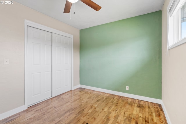 2222 34th Ave, Albany, OR 97322 - unfurnished bedroom with baseboards, wood finished floors, a closet, and a ceiling fan