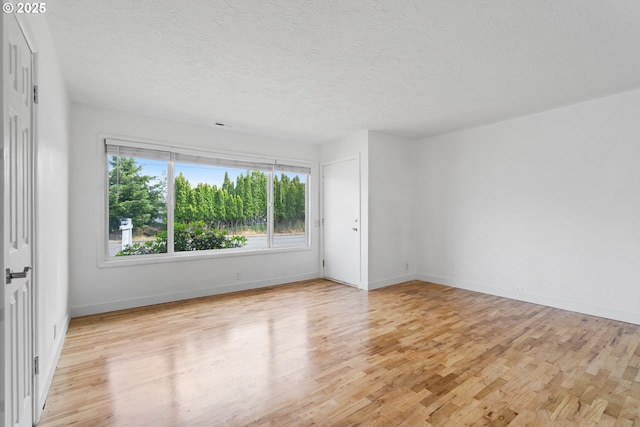 2222 34th Ave, Albany, OR 97322 - unfurnished room featuring light wood finished floors, a textured ceiling, and baseboards