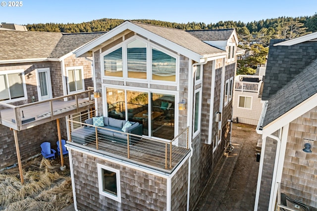 exterior space featuring a shingled roof