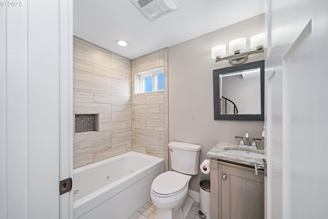 bathroom with toilet, vanity, visible vents, baseboards, and a combined bath / shower with jetted tub