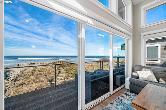 interior space featuring a water view, plenty of natural light, and a beach view