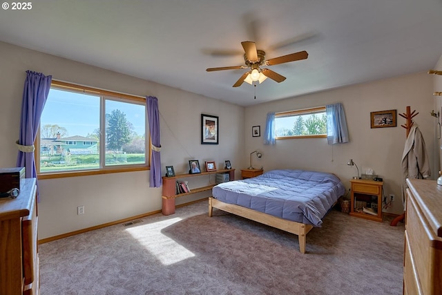 bedroom with visible vents, carpet flooring, baseboards, and ceiling fan