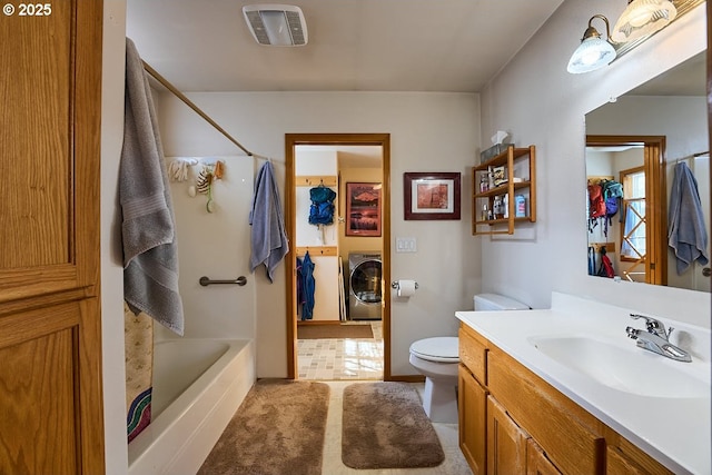 bathroom featuring visible vents, vanity, toilet, washtub / shower combination, and washer and dryer