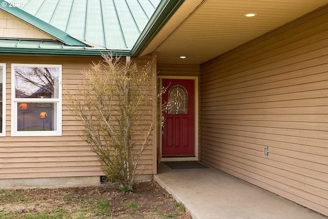 entrance to property featuring metal roof