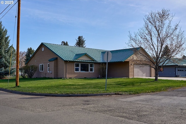 single story home with metal roof, a front yard, and a standing seam roof