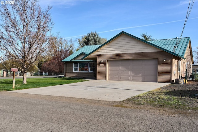 ranch-style home featuring an attached garage, driveway, metal roof, and a front lawn