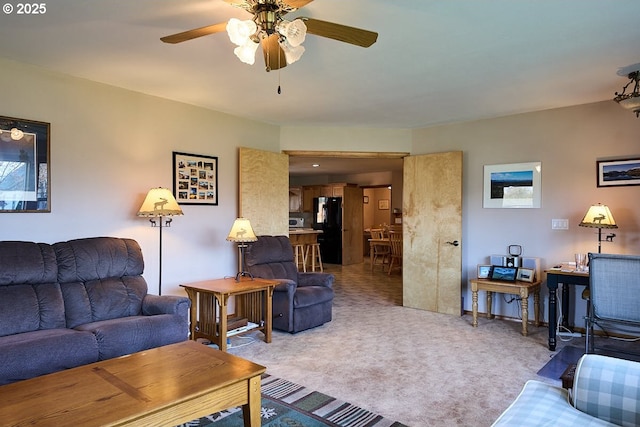 living room featuring ceiling fan and carpet flooring