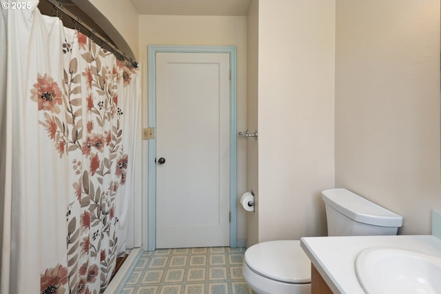 bathroom with toilet, vanity, tile patterned floors, and a shower with shower curtain