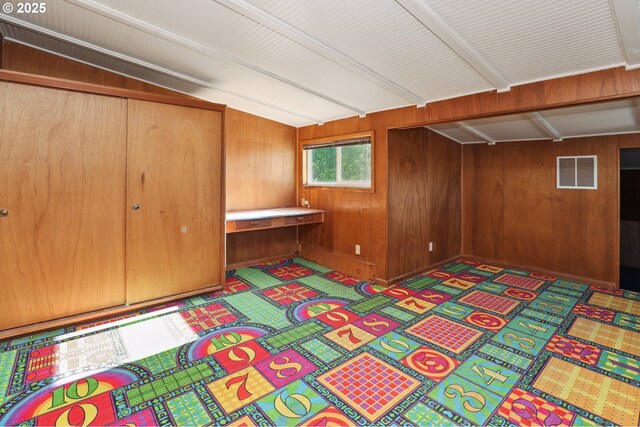 below grade area featuring wood walls