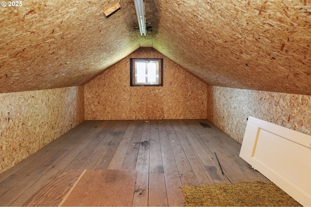 bonus room featuring hardwood / wood-style flooring and vaulted ceiling