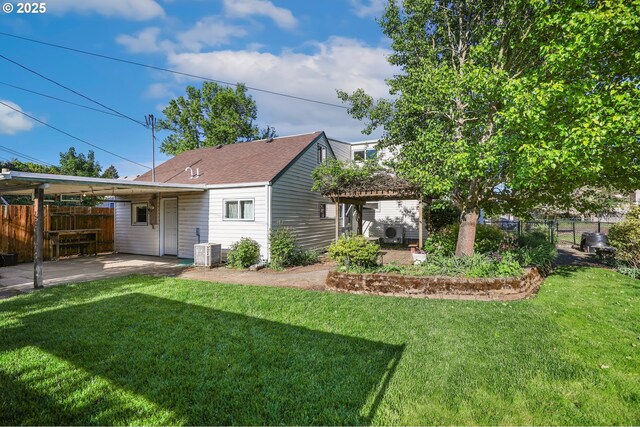 rear view of property with cooling unit and a carport