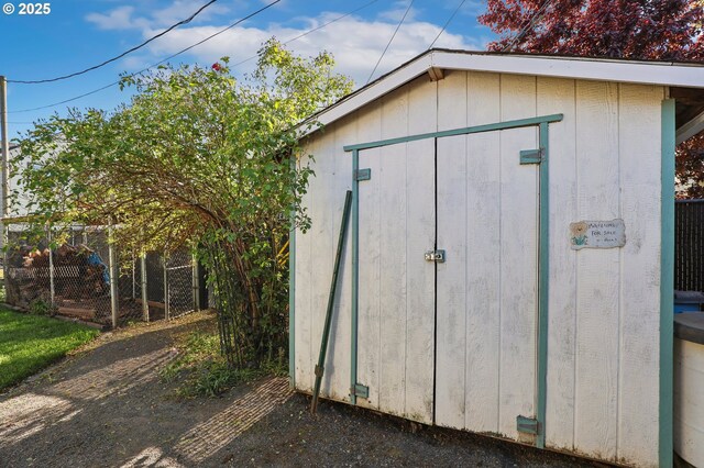 view of shed with fence