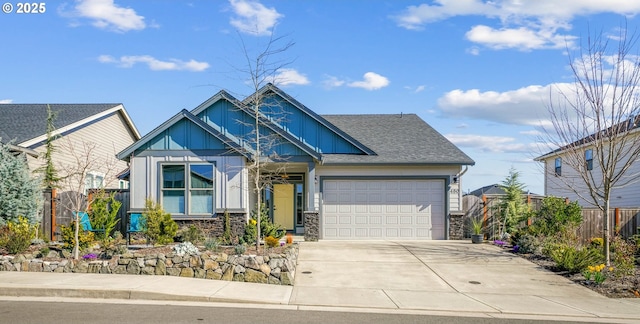 craftsman-style house featuring an attached garage, driveway, fence, and board and batten siding